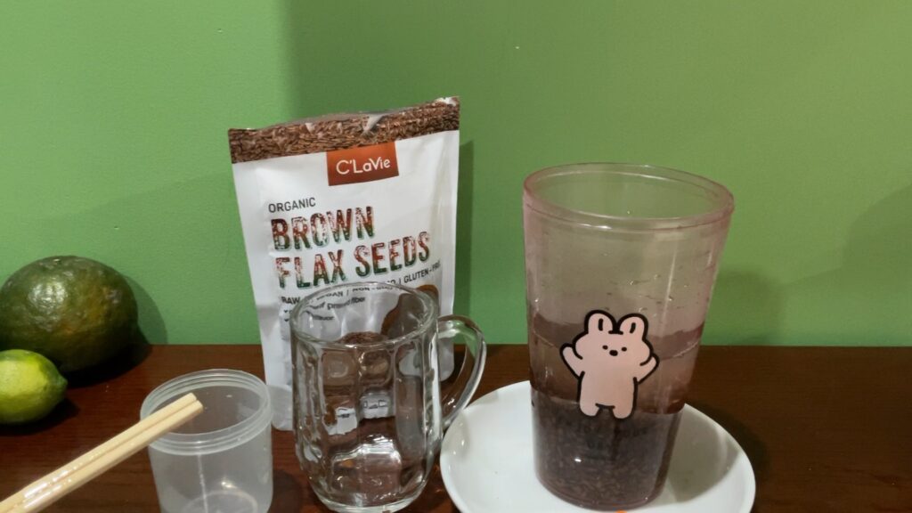 image of bag of flax seeds and cup and supplies for making on a desk