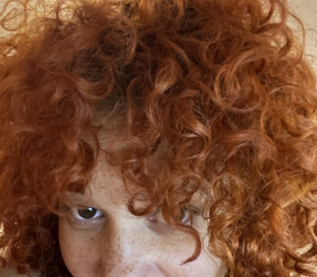 close up shot of authors curly red hair and freckles 